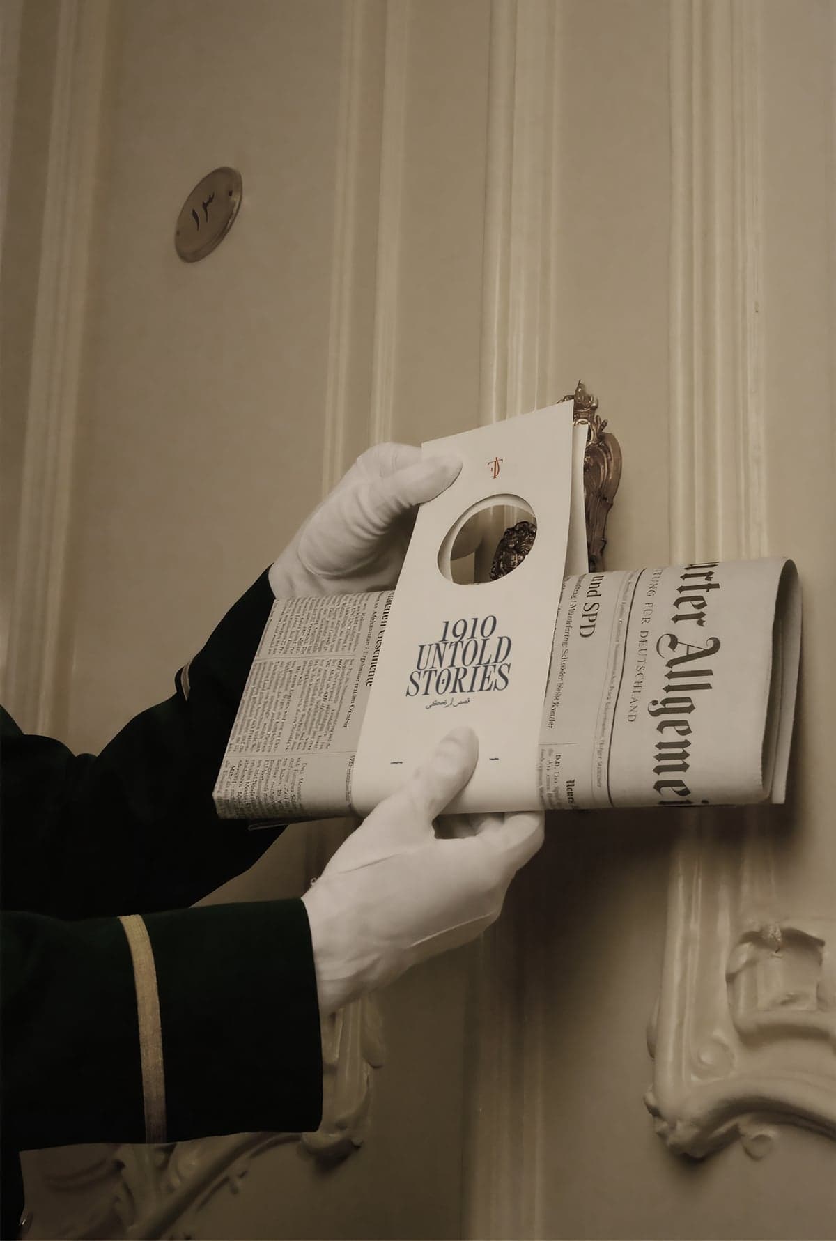 A doorman in white gloves holding a folded newspaper