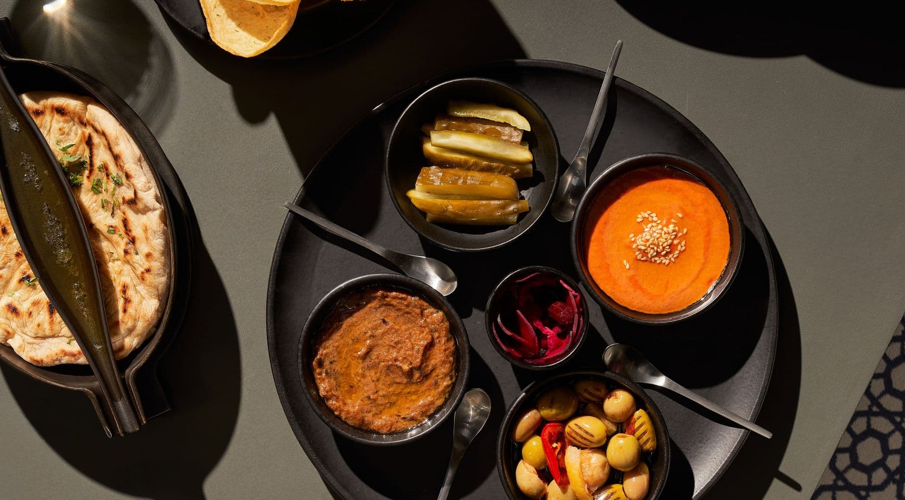 Mezze, olives, pickles and grilled flatbread laid out at The Bank Bistrot.